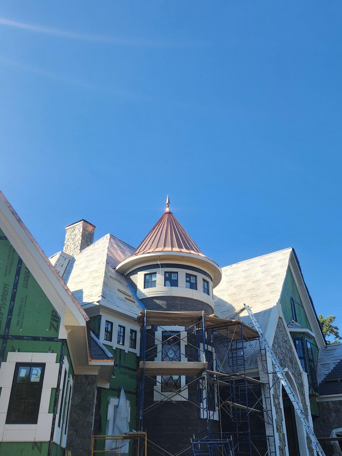 Copper turret and slate roofing on custom home