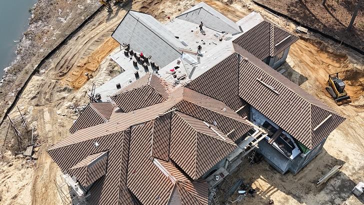 Aerial drone shot of tile roof installation